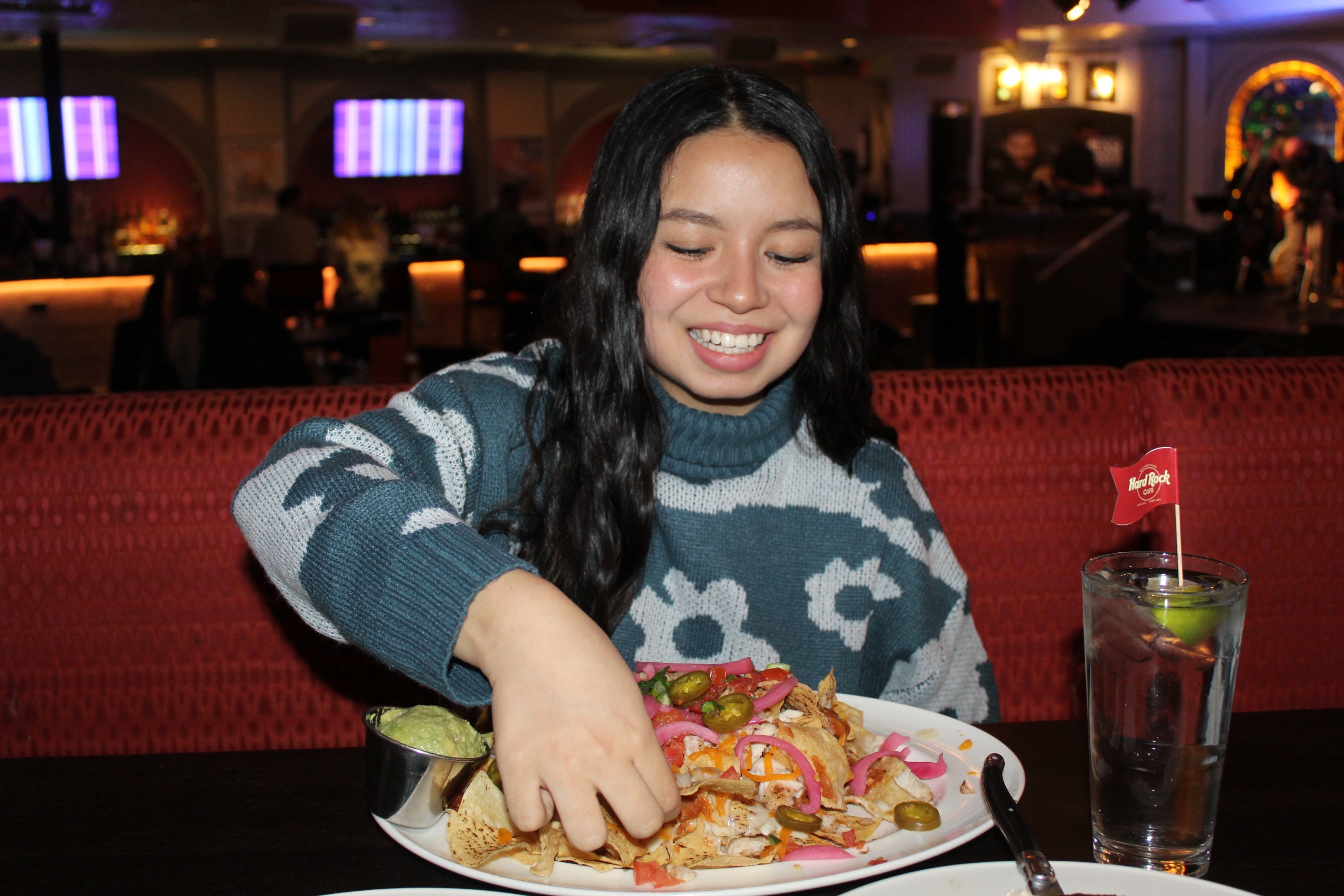 Girl eating nachos at a restaurant.